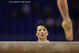 The Chinese women's coach keeps a careful eye on the technique of her gymnast practising on the Beam.