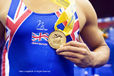A cropped generic image of the hand of a British Junior gymnast holding his gold medal at the 2010 European Gymnastics Championships in Birmingham.