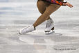 A cropped action generic image of a female skater's feet during a sit spin with reflections in the ice at the 2010 Winter Olympic Games in Vancouver.