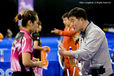 The coaches of Lee Eun Hee (Korea) and Wen Jia (China) appear to be giving similar advice to their players during a break in the match.