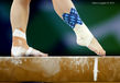 A generic image of a gymnast sporting tartan ankle taping while competing on beam during the Gymnastics competitions at the 2014 Glasgow Commonwealth Games.