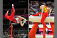 Kazuhitu Tanaka (Japan) left fails a move while competing on High Bar and Zou Kai (China) misses on Pommel Horse during the Men's Artistic Gymnastics competition at the 2012 London Olympic Games.