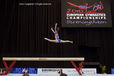 A wide angle generic image of a gymnast leaping on the beam at the 2010 European Gymnastics Championships in Birmingham