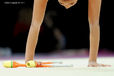 A cropped generic image of a gymnast competing with Clubs at the World Rhythmic Gymnastics Championships in Montpellier.