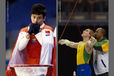 A double image of portraits of gymnasts collecting themselves before competing at the 2009 London World Artistic Gymnastics Championships - China's Feng Zhe left and Brazil's Zanetti Navarrete who receives a kiss for luck from his coach.