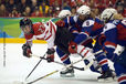 Canada's Gina Kingsbury takes a tumble after being tackled by Slovakia's Petra Babiakova in their match at the 2010 Winter Olympic Games in Vancouver.