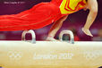 A generic image of a Chinese gymnast competing on Pommel Horse decorated with the Olympic Rings and Logo at the 2012 London Olympic Games.