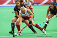 An action image of England's Alex Danson showing holding off opposition as she goes on the attack during the England Versus Germany match at the 2010 Women's World Cup Hockey Tournament in Nottingham