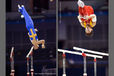 George Foo (Sweden) left and Feng Zhe (China) right perform difficult dismounts while competing on Parallel Bars at the 2009 London World Artistic Gymnastics Championships.