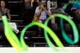 A cropped generic image of a photographer in the audience photographing a gymnast competing with Ribbon at the World Rhythmic Gymnastics Championships in Montpellier.