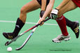 A cropped generic action image of an England and a German player chasing the ball during their match at the 2010 Women's World Cup Hockey Tournament in Nottingham
