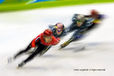 A blurred motion image of short track speed skaters in training at the 2010 Winter Olympic Games in Vancouver.