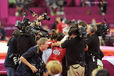 The USA women are completely surrounded by TV cameras and pool photographers after winning the team event during the gymnastics competition of the London 2012 Olympic Games.